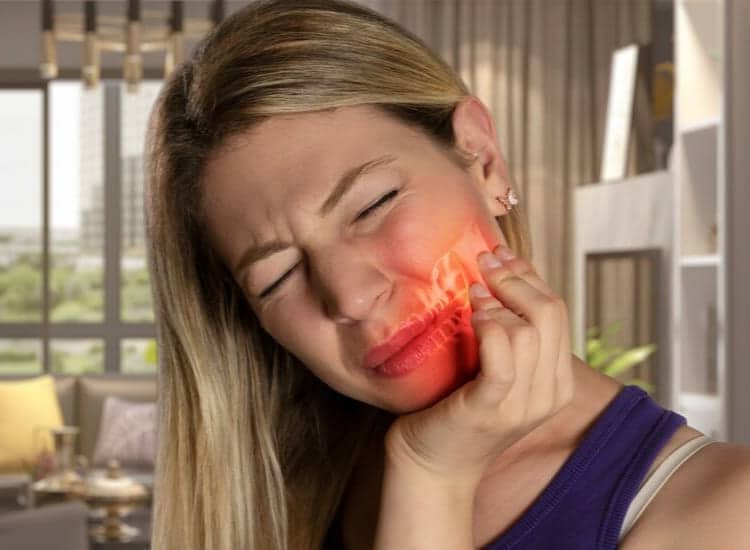 A woman with jaw pain needing temporomandibular joint treatment from a dentist.