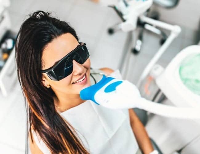 A woman about to start a laser dental treatment
