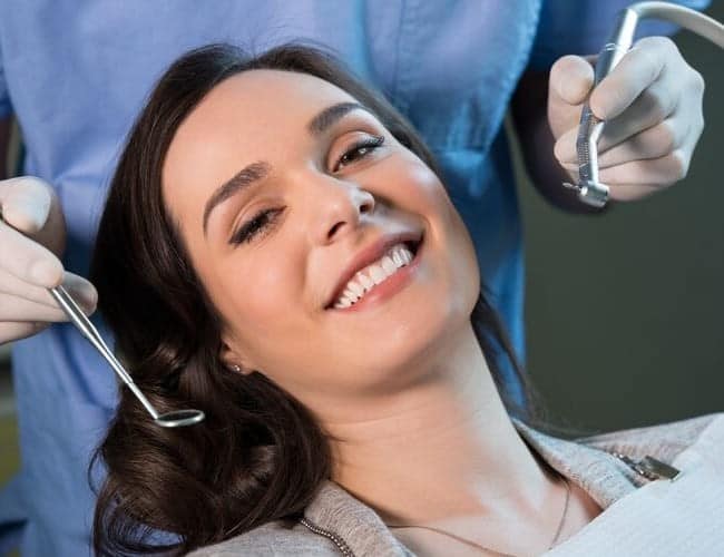 A woman smiling as she gets ready for her general dentistry treatment