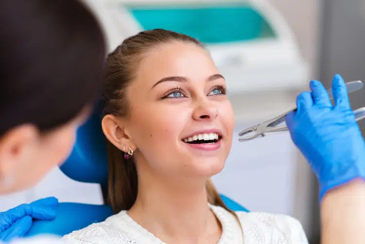 A young woman getting ready to get one of her teeth extracted by a dentist
