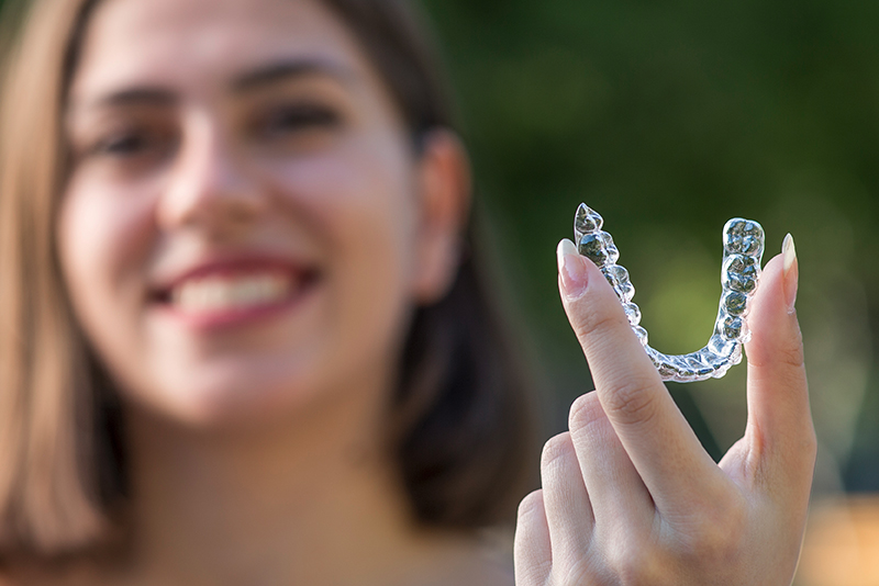 Woman holding her dental invisalign.
