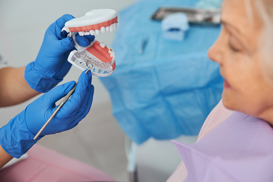 Dentist explaining Crowns vs Implants to patient
